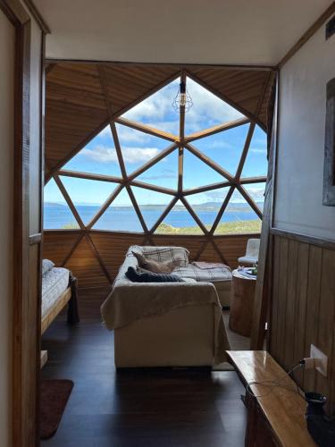 a room with two beds and a large window at Domo Buena Vista 