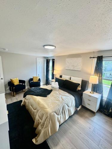a bedroom with a large bed and a couch at Modern House near OSU and Short North in Columbus