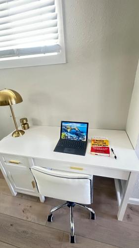 a white desk with a laptop computer on it at Modern House near OSU and Short North in Columbus