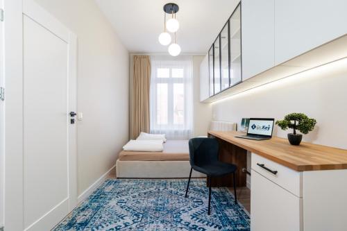 a small room with a desk and a bed at K26UrbanNest in Wrocław