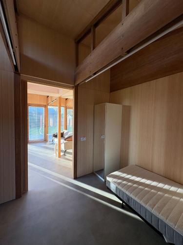 a bedroom with a bed and a sliding glass door at Bamboo House in Boyl