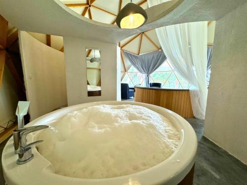 a bathroom with a large white tub in a room at In Out in Antalya