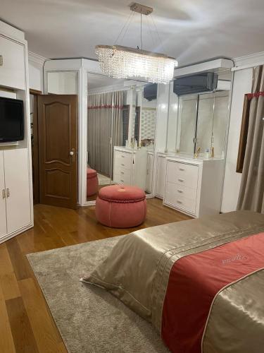 a bedroom with a bed and a chandelier at Lux House in Ferreira