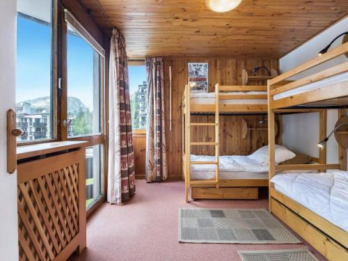 a bedroom with two bunk beds and a large window at Appartement au centre de Val d'Isère, 3 pièces, 6 pers., avec WiFi - FR-1-567-60 in Val dʼIsère