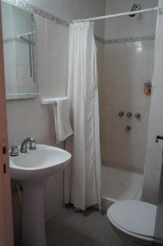 a bathroom with a sink and a shower and a toilet at Hotel coventry in Santiago del Estero