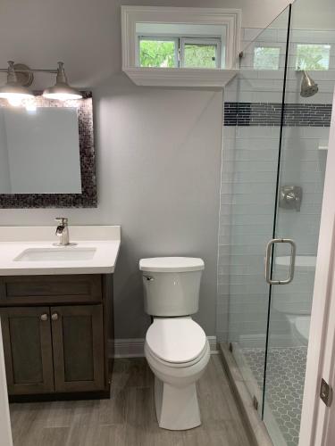 a bathroom with a toilet and a sink and a shower at Creole Nest in New Orleans