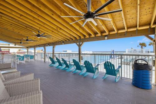 a deck with chairs and a ceiling fan at The Maverick Resort - Ormond Beach in Ormond Beach