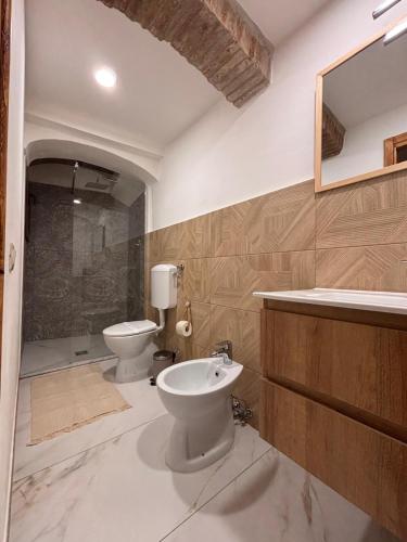 a bathroom with a toilet and a sink at B&B Note di Verdi in Parma
