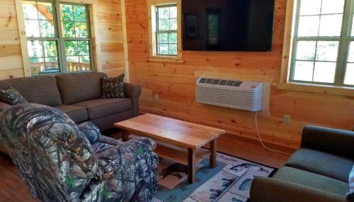 a living room with a couch and a table at Rustic Family-Friendly Accommodation with Jacuzzi near Huntington, West Virginia in Genoa