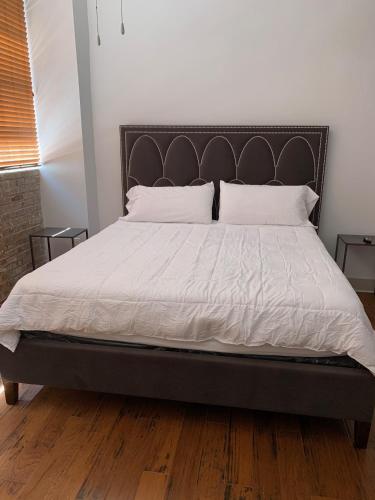 a bed with white sheets and pillows in a bedroom at Creole Nest in New Orleans