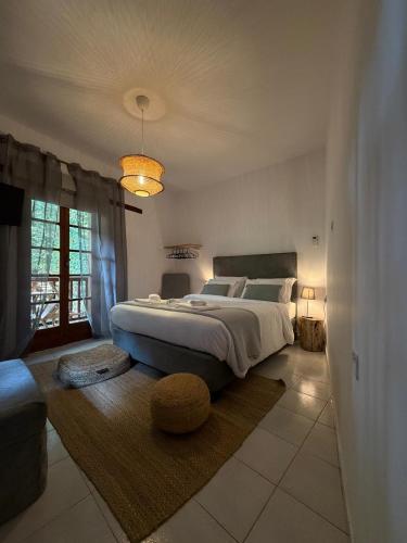 a bedroom with a large bed and a large window at GaliniCafe22-suites in Kakopetria