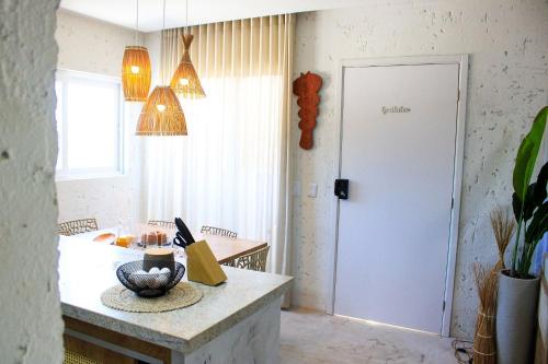 a kitchen with a table and a white door at MHV Milagres - Casa Corais, Curimã D9 in Passo de Camarajibe