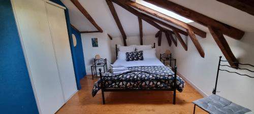a bedroom with a bed in a attic at Chambres d'hôtes de Massigoux in Aurillac