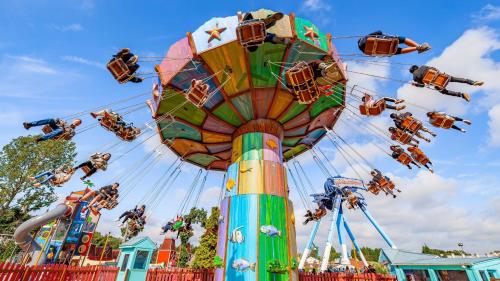 a ferris wheel at a carnival with many rides at Holiday Inn Express Burton Upon Trent by IHG in Burton upon Trent