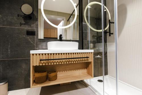 a bathroom with a sink and a mirror at VacationClub - Baltic Waves Resort Apartament A109 in Międzyzdroje
