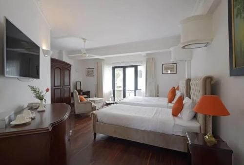 a large bedroom with a bed and a desk at Dalat Villaa in Da Lat