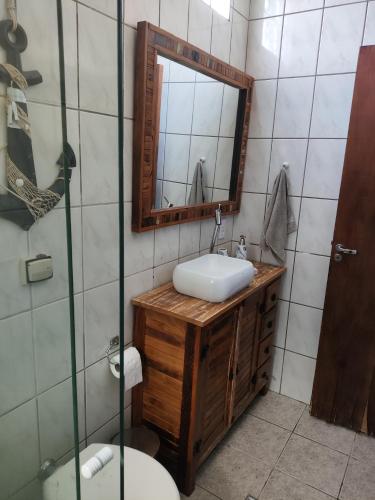 a bathroom with a sink and a mirror at Praia litoral norte SP 70 m praia in Caraguatatuba