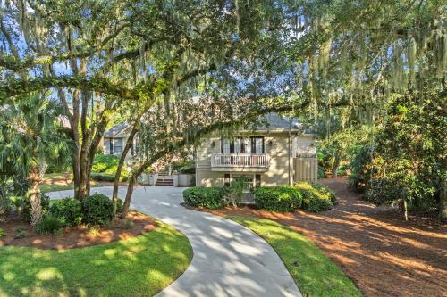 a house with a walkway in front of a yard at Cane Current in Hilton Head Island