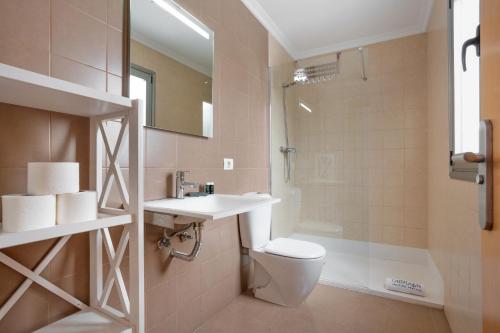 a bathroom with a toilet and a sink and a shower at Obsidian Aregoma La Caleta in Adeje