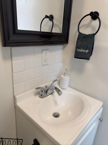 a white sink in a bathroom with a mirror at Las Casita-Cozy Apartment near Airport, Downtown, UTEP, Fort Bliss in El Paso