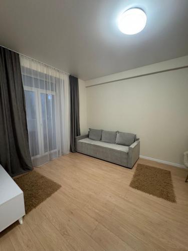 un soggiorno con un divano e una finestra di Квартира a Dnipro