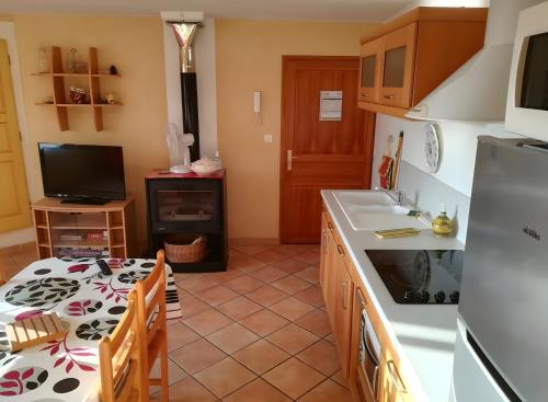 サント・クロワ・デュ・ヴェルドンにあるL'amourié, Rdc, Gîte 4 Personnesのキッチン(テーブル、シンク、カウンタートップ付)