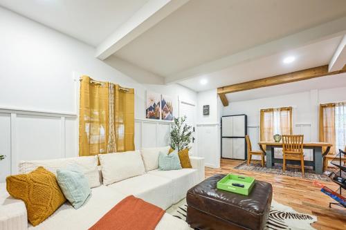 a living room with a white couch and a table at Charming Cabin with Hot Tub, Fireplace, Fire Pit, 2 minutes to downtown in Ellijay