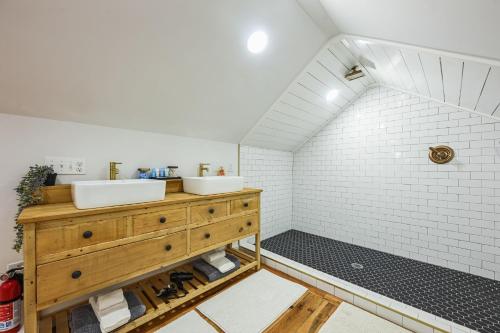 a bathroom with two sinks and a white tiled wall at Charming Cabin with Hot Tub, Fireplace, Fire Pit, 2 minutes to downtown in Ellijay