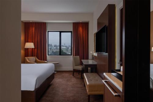 a hotel room with a bed and a desk at Radisson Blu Hotel, Addis Ababa in Addis Ababa