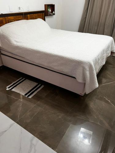 En eller flere senge i et værelse på Casa completa com piscina e hidromassagem