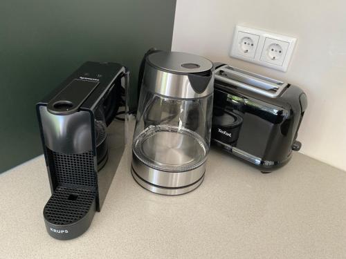 a blender and a coffee maker on a counter at Huize de Lekpoort - The City View - Historic Apartment in Vianen Center in Vianen