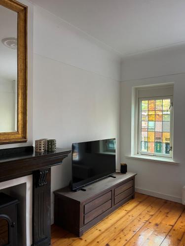 a living room with a flat screen tv sitting on a entertainment center at Characteristic Dutch home in historic center Gouda in Gouda