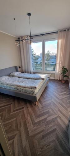 Ένα ή περισσότερα κρεβάτια σε δωμάτιο στο Apartament Skarbowa West