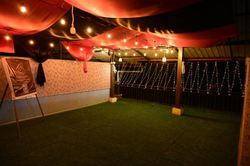 a room with a tennis court with lights on it at KK Residences in Madikeri