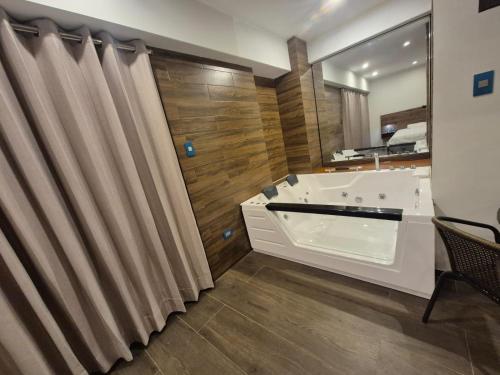 a bathroom with a tub and a shower curtain at Hotel Zaniah in Huancayo