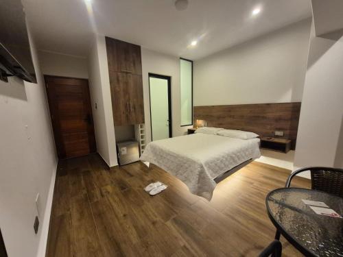 a bedroom with a bed and a wooden floor at Hotel Zaniah in Huancayo