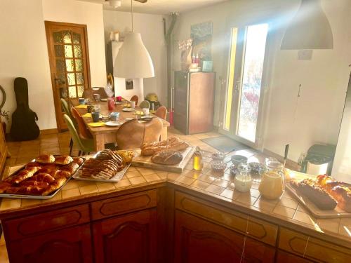 a kitchen with a counter with various pastries on it at LES HAUTS DE BARROU Chambres d'Hotes in Saint-Jean-de-Barrou