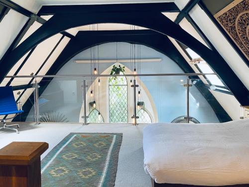 a bedroom with a white bed and a window at Fabulous Converted Church Apartment Town Centre in Worthing
