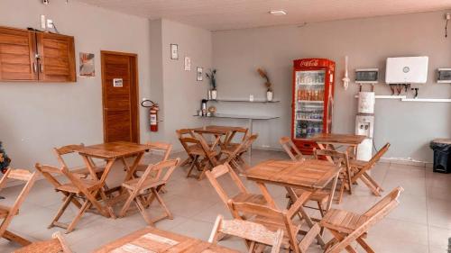 a restaurant with wooden tables and chairs in a room at Arejar Hotel in Juruti