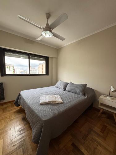 a bedroom with a bed and a ceiling fan at Departamento Bloom in Bahía Blanca