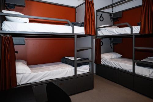 a room with three bunk beds and a chair at Hotello Padova in Padova