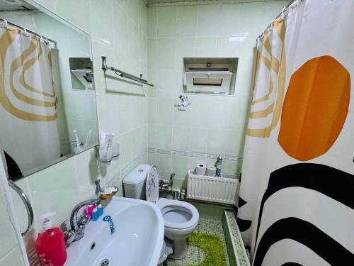 a bathroom with a white sink and a toilet at Guesthouse Gorilla 