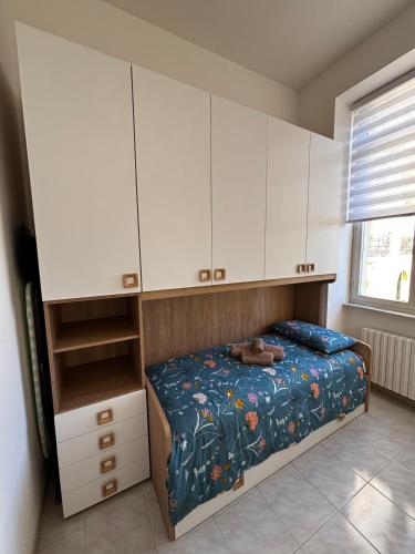 a bedroom with a bed and white cabinets at Sweet home in Bordighera