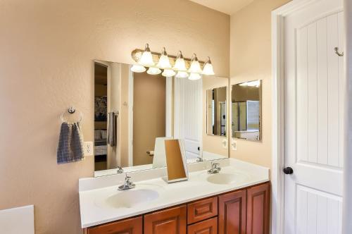 a bathroom with two sinks and a large mirror at Pine Mountain Trail Pool Table Dog Family Fun in Flagstaff in Flagstaff