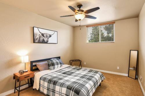 a bedroom with a bed and a ceiling fan at Pine Mountain Trail Pool Table Dog Family Fun in Flagstaff in Flagstaff