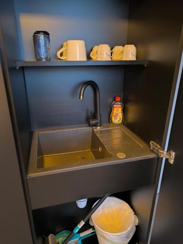 a kitchen sink in a refrigerator with a shelf at Studio am Waldrand in Bad Hersfeld
