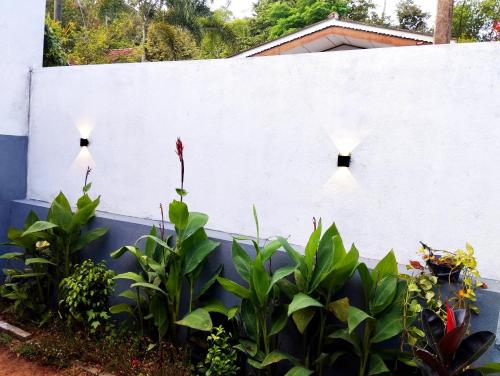 a white fence with three lights on it at Junction 14 Villa in Dikwella North