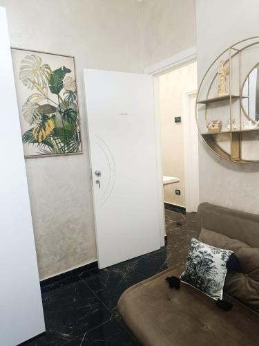 ein Wohnzimmer mit einer Couch und einer weißen Tür in der Unterkunft BeB Imperial in Catanzaro