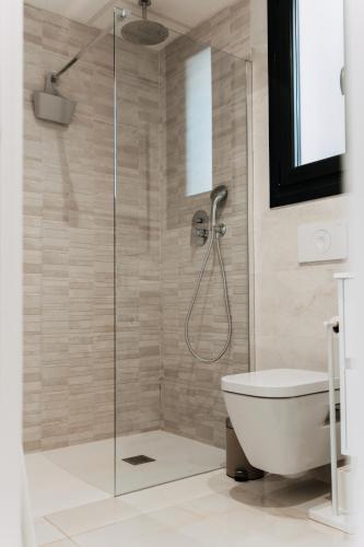 a bathroom with a glass shower with a toilet at Casa Madie - Sea view in Orihuela Costa