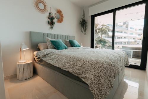 a bedroom with a bed and a large window at Casa Madie - Sea view in Orihuela Costa